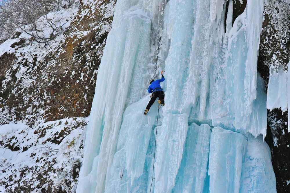 中央最大の氷爆を登るクライマー。春が近づくと氷に亀裂が入る。亀裂の瞬間は、ドンと爆音が谷に響く